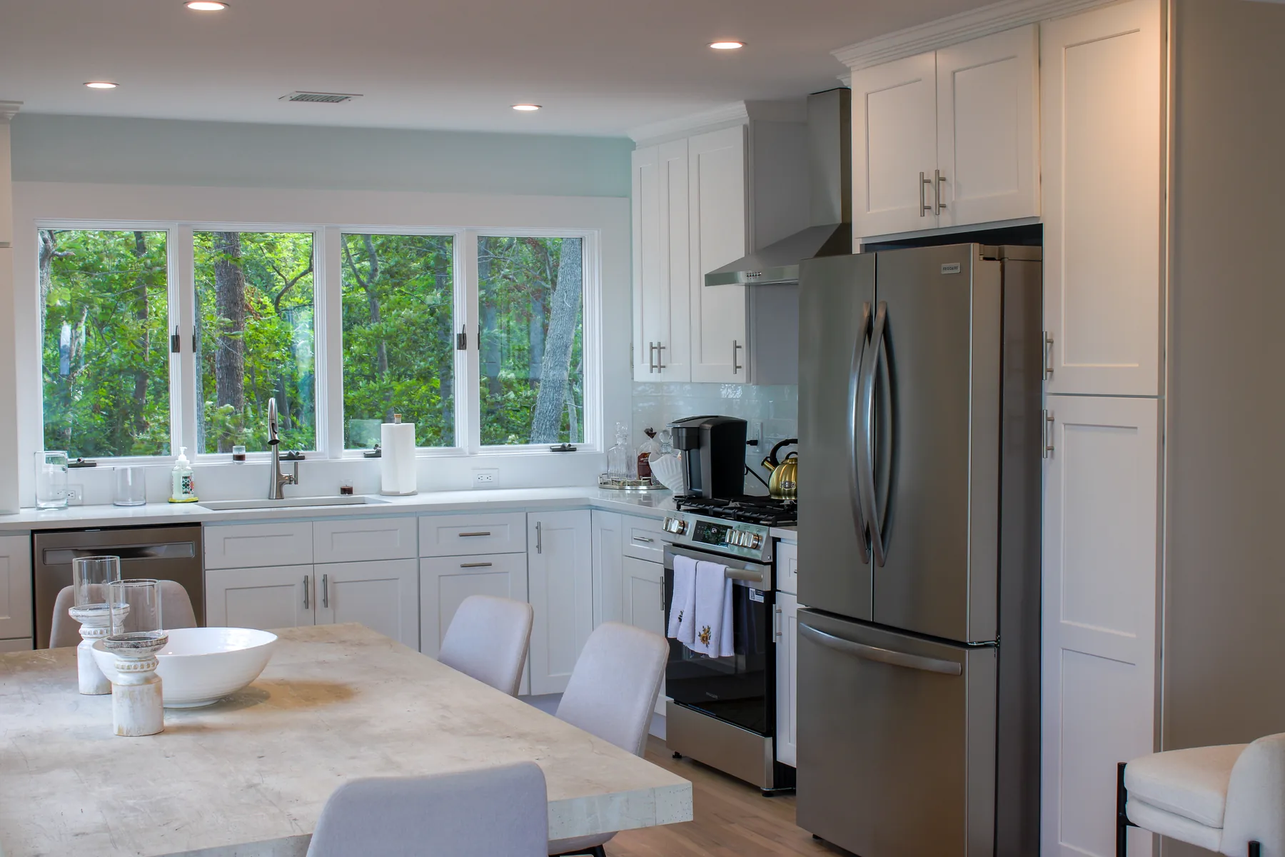 Renovated kitchen at 46 Red Cedar Point Road with white cabinetry and a stone-topped island